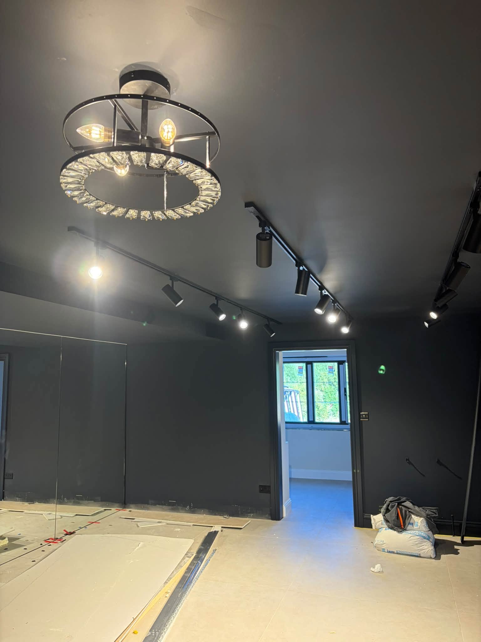 Track lighting and a feature ceiling light